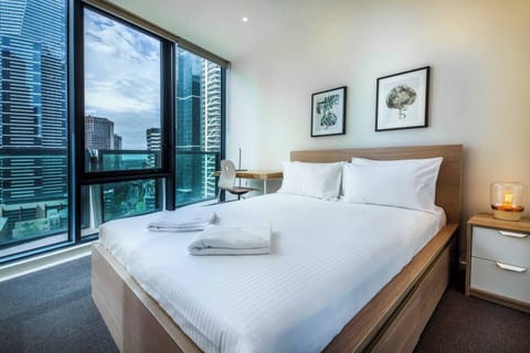 Two spacious bedrooms come with built-in mirrored wardrobes and floor-to-ceiling windows, as well as queen beds