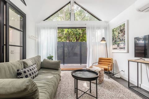 Relax in the living area, complete with TV for your entertainment, and enjoy the added privacy provided by the sheer curtains.
