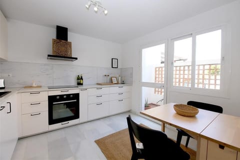 Modern kitchen with dining table for two and extra terrace with gas barbecue