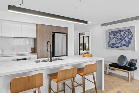 The kitchen offers ample prep space for cooking at home and modern appliances including an oven and a dishwasher. 