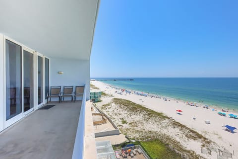 This large balcony offers a stunning beachfront view with comfortable seating for relaxation after a day at the beach