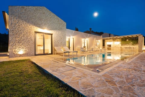 Night chilling%2Dout on a stone hued pool patio