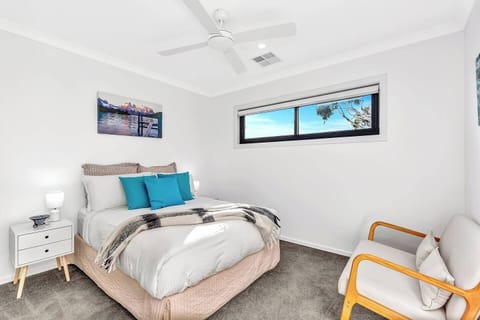 The second bedroom also features a queen-sized bed, along with side tables, reading lights, and a comfortable sofa chair for your relaxation and reading pleasure.