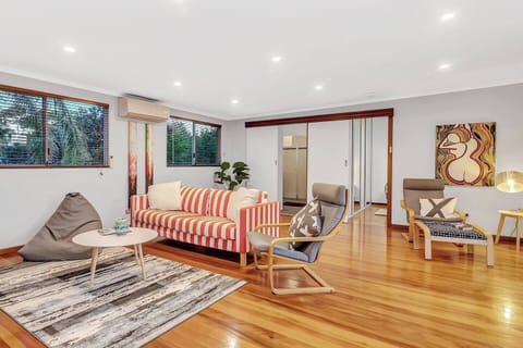  The main living room upstairs offers plenty of seating for everyone to settle in with a movie, while split system air-conditioning ensures year-round comfort. 
