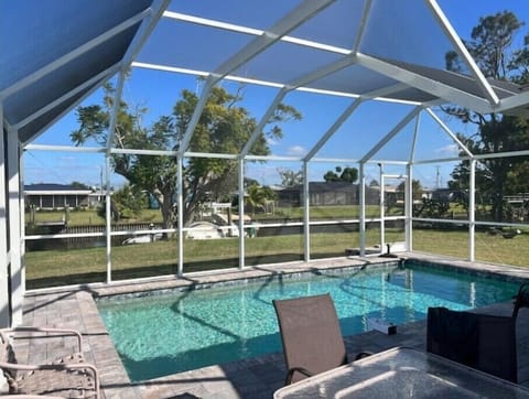 Pool area with sitting area Lounge chairs and Bbq