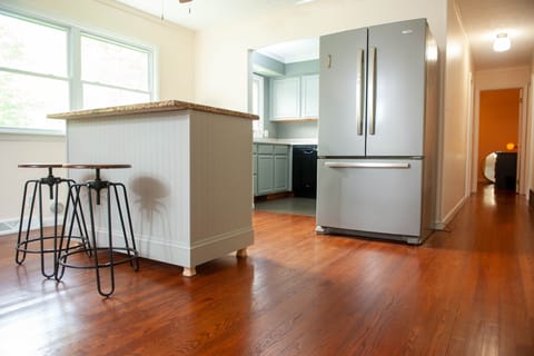 Handmade island with storage, water dispenser, fridge/freezer and kitchen.