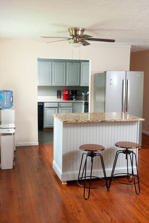 Handmade island with storage, water dispenser, fridge/freezer and kitchen.