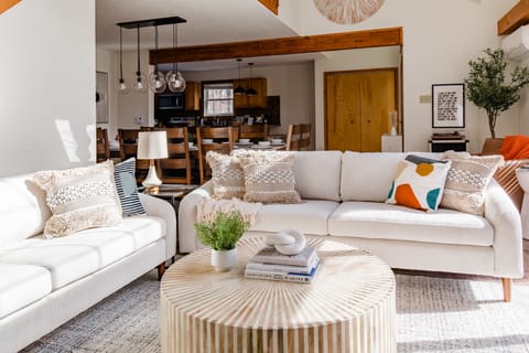 Lounge in the living room while the kitchen comes alive with culinary delights.