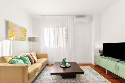 Unwind in the living area with a comfortable leather sofa, Smart TV and light-filled interiors that offer a welcoming place to recharge after exploring Sydney.