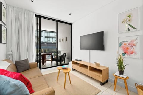 This modern apartment features streamlined interiors with an open plan design that flows to the balcony.
