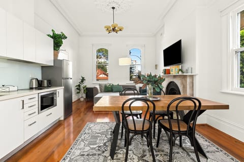 Share meals or settle in with your laptop at the dining area, where a timber table and classic Bentwood chairs create a welcoming setting for dining or remote work.