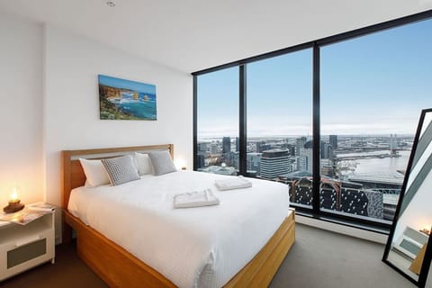 The master bedroom is lined with floor-to-ceiling windows, letting in loads of natural light and showcasing the beautiful views 

