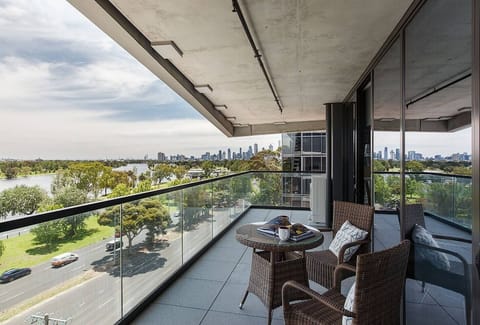 Step out onto the spacious balcony, directly accessible from the living room, and unwind with outdoor seating while soaking in the lush greenery and serene lake views.