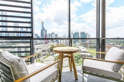 A private balcony is comfortably furnished with a two-seater setting where guests can kick back with a glass of wine at sunset and take in the spectacular view.  