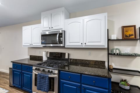 Chef's kitchen with gas stovetops and plenty of cookware, bakeware, and dining sets enough for 16!