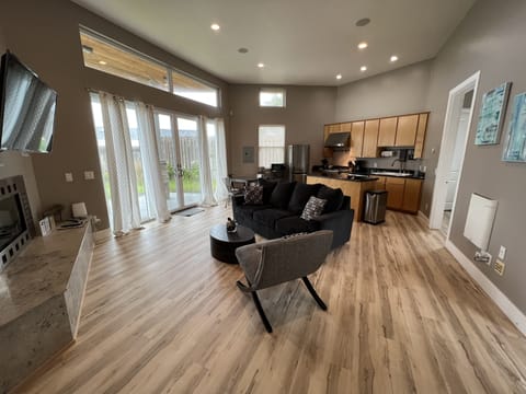 Living room and kitchen from front door Lots of light and patio.
