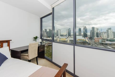 A master bedroom comes furnished with a queen bed, built-in wardrobes and stunning views of Southbank