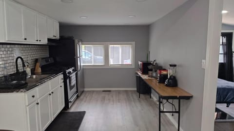 Kitchen with microwave, Keurig coffee maker, blender, and toaster