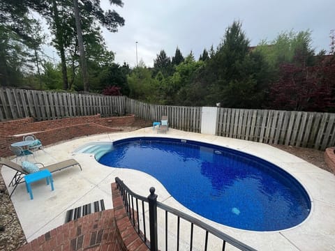 Private pool located in the fenced in backyard