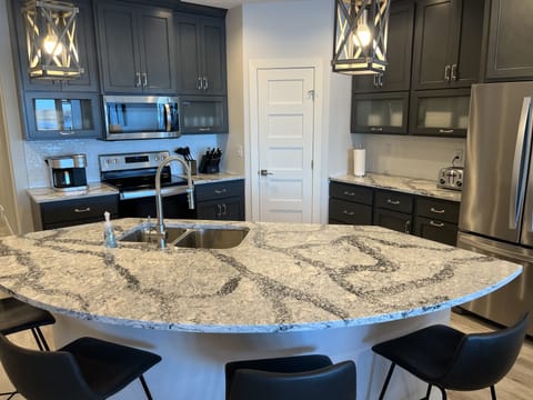 Fully furnished kitchen with island seating for four. 