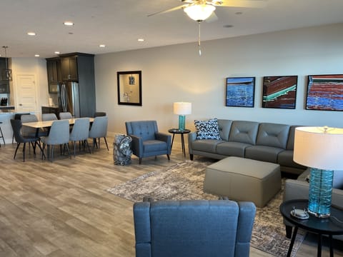 Comfortable leather sectional seating with lake views, plus two side chairs.