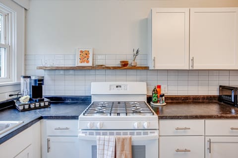 The kitchen features a gas rang and keruig  coffee maker