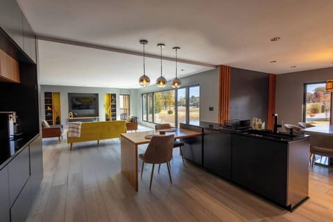 Open view from the kitchen, seamlessly connecting the dining and living areas, creating an inviting, airy space for both cooking and socializing.