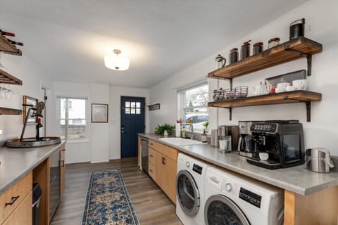 You will enter through our Welcome Room equipped with Coffee Bar,  Wine Bar and beverage fridge. Small laundry to the right.