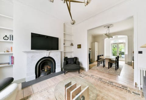 large upstairs living/ dining/ kitchen with 10' ceilings, French doors to garden