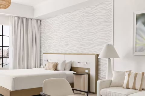 Unwind in a sunlit suite with crisp linens and calm tones.