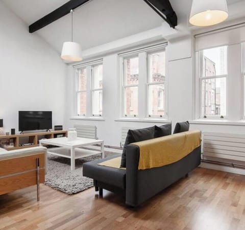 Kick back on the sofa and stream your favourites on Netflix in this bright, loft-style living space with soaring ceilings and exposed beams