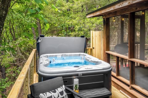 Soak, sip, and stargaze just steps from your private log cabin door