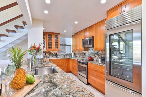Create family feasts in this stunning Maui kitchen, fully equipped with high-end appliances, granite counters, and ample space. Perfect for cooking meals together, saving money, and enjoying fresh island flavors right from your own vacation home.