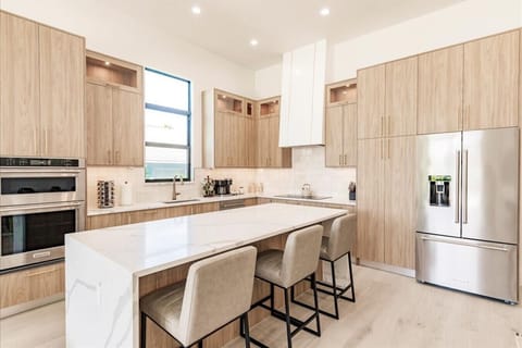 High Ceilings Gourmet Kitchen with Barstool Seating.