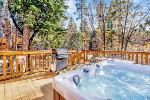 Outdoor area with a BBQ grill, relaxing hot tub, and spacious backyard, perfect for enjoying fresh air, gathering with friends, or unwinding under the open sky.