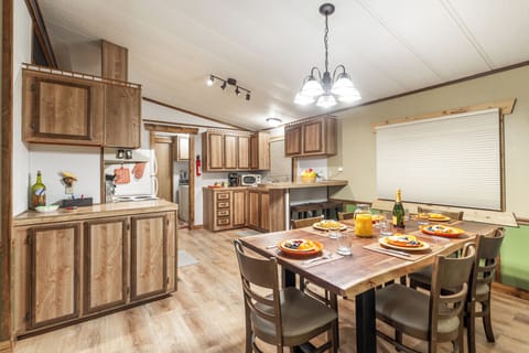 Share hearty meals and fresh conversation in this warm, wood-accented kitchen and dining area, complete with everything you need to feel right at home.