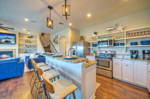 Fully equipped kitchen with barstool seating.