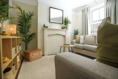 The Living Room is a cosy space with two comfortable sofas and a smart TV.