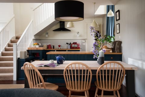The Old School, Hume - dining table with kitchen beyond
