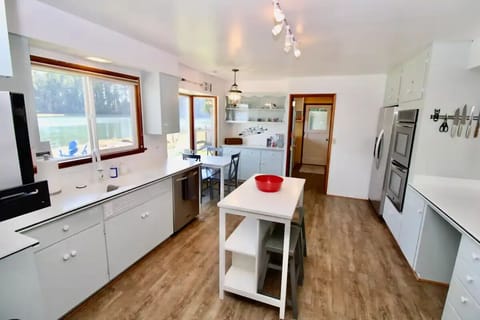 Island with seating for 2 and a table with seating for 3. 