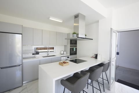 Fully Equipped kitchen complete with island and extra seating for 3 people