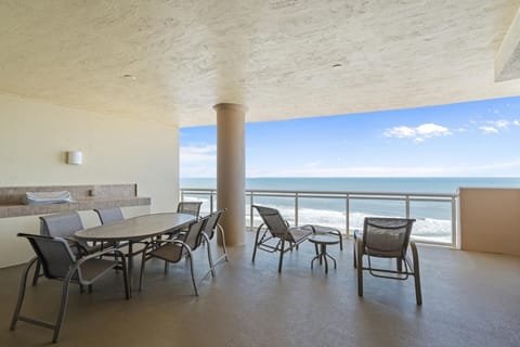 Spacious oceanfront patio with panoramic sea views and dining area