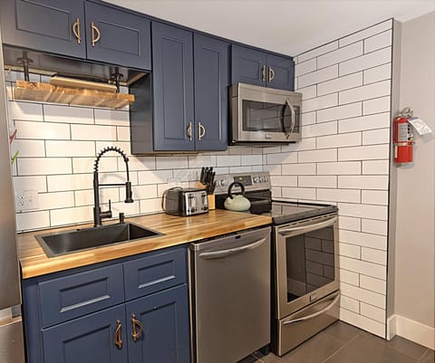 Stainless steel appliances, deep gourmet sink, and backsplash are just some of the kitchen amenities.