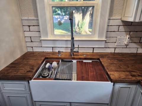 Deep pot farmhouse sink with stunning butcher's block countertops.