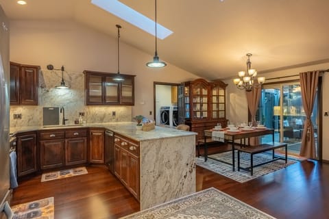 Dining, kitchen and washer/dryer area