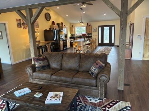 Living room with Dish tv and open to kitchen. 