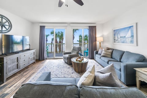 Sink into coastal comfort in your spacious living room, where ocean breezes flow through your private balcony.
