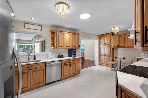 Designed for both cooking and entertaining, the kitchen offers abundant cabinet space and modern finishes.