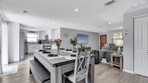 A spacious dining table for 8 takes center stage, ready to host memorable meals and gatherings.