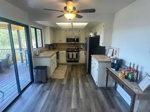 Fully equipped kitchen with electric range and dishwasher.